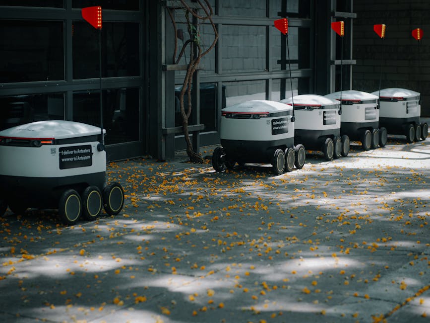 Autonomous delivery robots lined up outdoors showcasing modern transportation technology innovations.